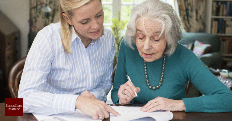 Senior couple reviewing financial documents to prevent elder financial exploitation and protect their savings.